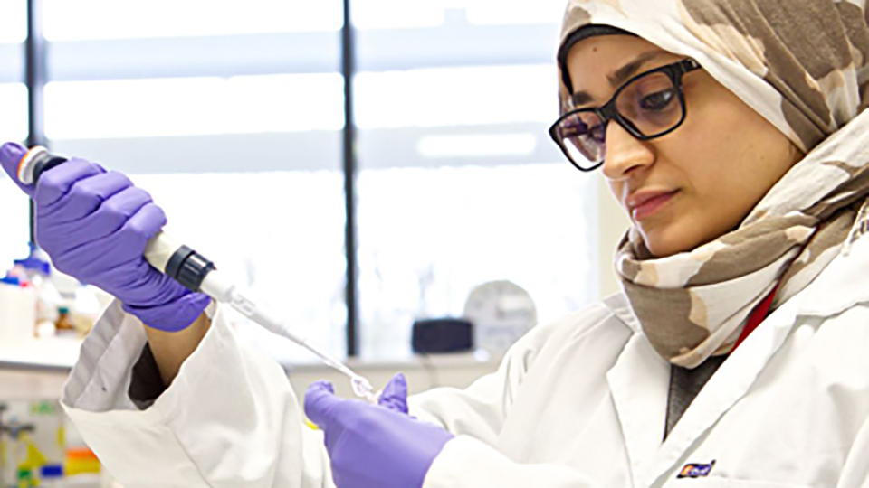 researcher using a pipette
